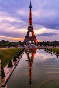 The Eiffel tower at sunset glistening in red