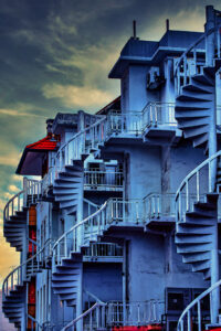 a row of old heritage houses with nack spiral staircases that lead to the rooftop in Singapore